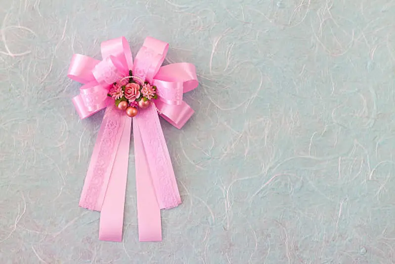 Pink bow with fabric flower on blue mulberry paper