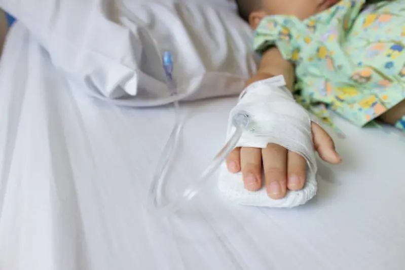 Baby boy hand give saline solution in bed in hospital