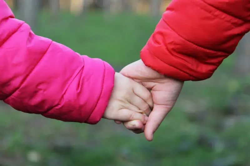 kids are holding hands of each other in winter day with nature backraund.