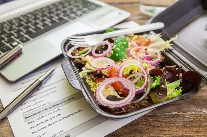 Healthy quinoa and mix of lettuce in a lunch box
