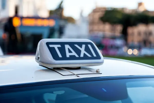 Close-up on a Taxi sign on the top of a Roman taxi.