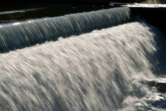 Beautiful flowing water over a cascading bridge forming stunning patterns and textures.showing the stunning movement of nature and the calm energy that exists. perfect for meditation and meditating