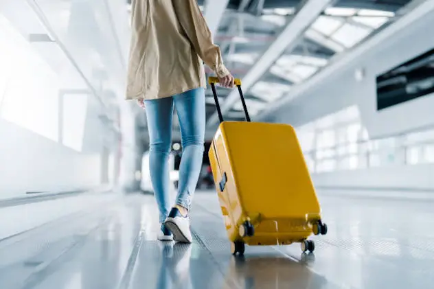 International airport terminal. Asian beautiful woman with luggage and walking in airport