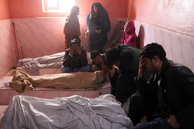 epa06476222 Relatives cry beside the bodies of children, who were killed when a rocked hit a civilian house in Qarabaghi village of Ghazni city while a military operation was going on near the area, after they were brought to a hospital in Ghazni, Afghanistan, 26 January 2018. Family members alleged that seven of their relatives from a same family, including two women and five children were killed when an Afghan military helicopter attacked their house during an operation against the Taliban militants that killed around 15 Taliban militants in Qararbaghi village of Ghazni.  EPA/SAYED MUSTAFA