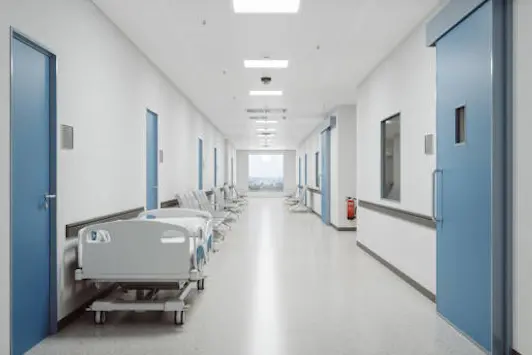 Corridor of an empty modern Japanese hospital with Japanese and English signages.