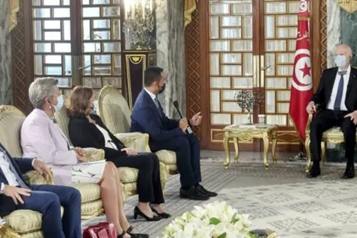 In this photo provided by the Tunisian Presidency, Italian Foreign Minister Luigi Di Maio, second from right, speaks with Tunisian President Kais Saied, right, in Carthage, near Tunis, Monday, Aug, 17, 2020. Top Italian and EU officials are holding talks in Tunisia on Monday to try to stem the growing numbers of migrants crossing from this North African country to Europe. (Slim Abid/Tunisian Presidency via AP)