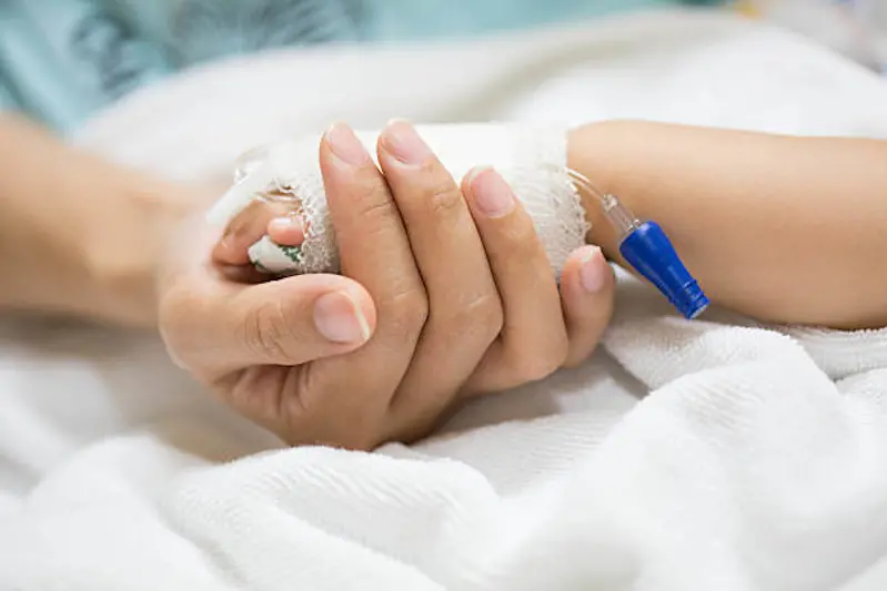 Mother holding a baby hand.