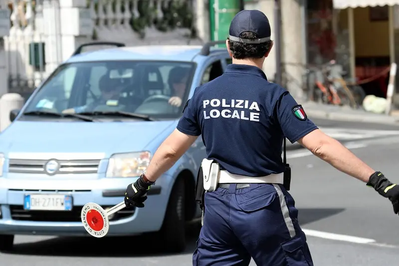 San Remo, Italy - June 10, 2018: Italian Policeman (Polizia Locale) in Uniform Controlling Road Traffic in The City Center of San Remo, Liguria, Italy