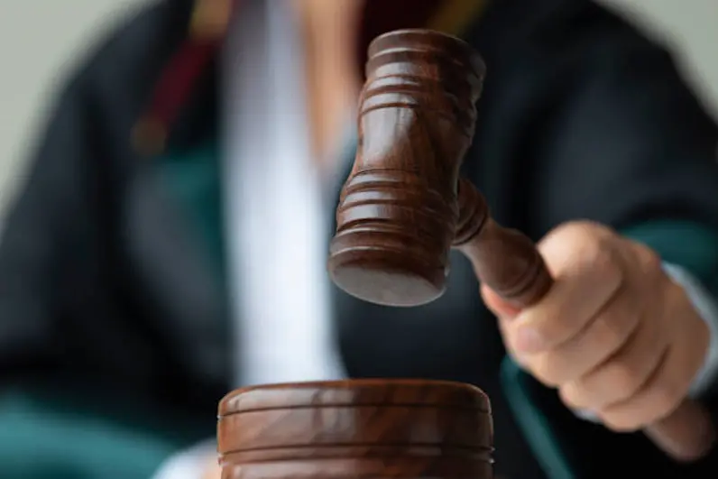 Woman holding gavel.