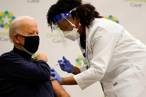 President-elect Joe Biden receives his first dose of the coronavirus vaccine at ChristianaCare Christiana Hospital in Newark, Del., Monday, Dec. 21, 2020, from nurse practitioner Tabe Mase. (AP Photo/Carolyn Kaster)
