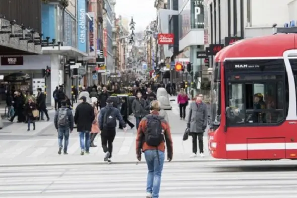 A view of Drottninggatan- Queens Street in Stockholm, Sweden, Wednesday April 1, 2020. The coronavirus is not keeping people in Sweden at home even while citizens in many parts of the world are sheltering in place. (Fredrik Sandberg/TT News Agency via AP)