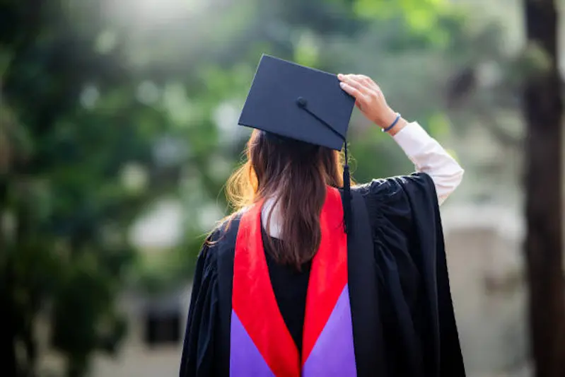 Graduation day, back view of young Asian woman students celebrate university graduation with copy space