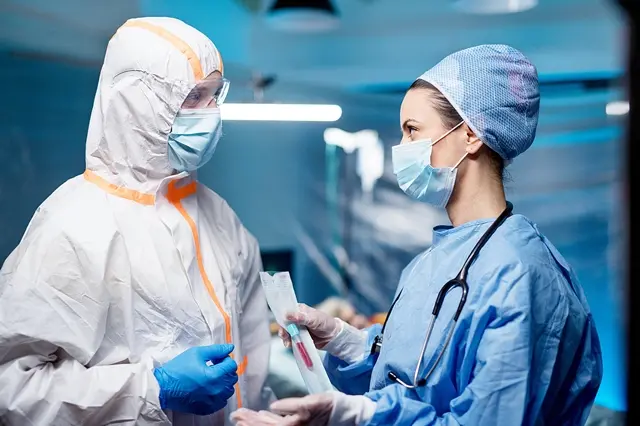 Doctors holding samples and talking in hospital, coronavirus concept.