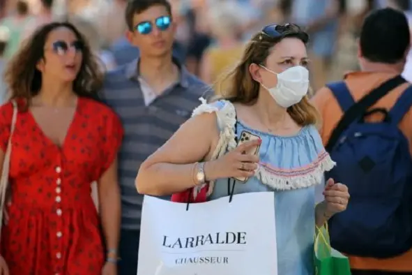 People walk the streets of Saint Jean de Luz, southwestern France, Saturday, July 18, 2020. New French Prime Minister Jean Castex has announced that respiratory masks will be mandatory in France in closed public places as of \\\\&quot;next week.\\\\&quot; (AP Photo/Bob Edme)