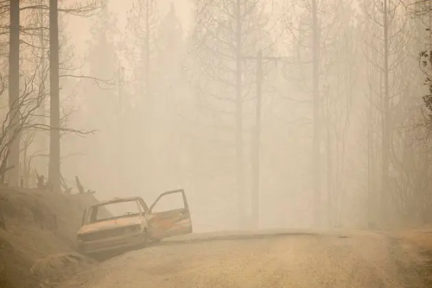 epa08667233 The charred remains of a vehicle along Graystone Lane burned by the Bear fire, part of the North Lightning Complex fires, in Berry Creek, California, USA, 13 September 2020. According to reports, more than 100 wildfires are burning across 12 Western US states.  EPA/PETER DASILVA