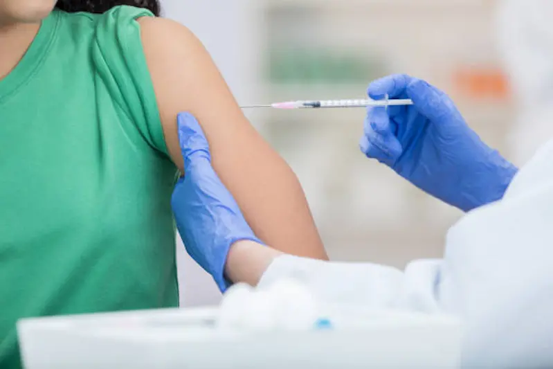 Healthcare professional gives girl a flu vaccine.