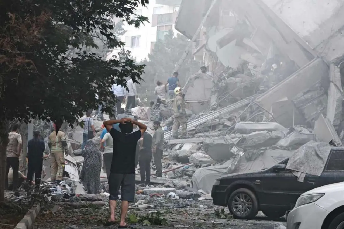 TEHRAN, IRAN - JUNE 13: People look over damage to buildings in Nobonyad Square following Israeli airstrikes on June 13, 2025 in Tehran, Iran. Iran\\'s three top military generals were killed in the attacks that also targeted nuclear and military facilities, according to published reports. Israel described the strikes as preemptive to keep Iran from obtaining nuclear weapons, the reports said.  (Photo by Majid Saeedi/Getty Images)